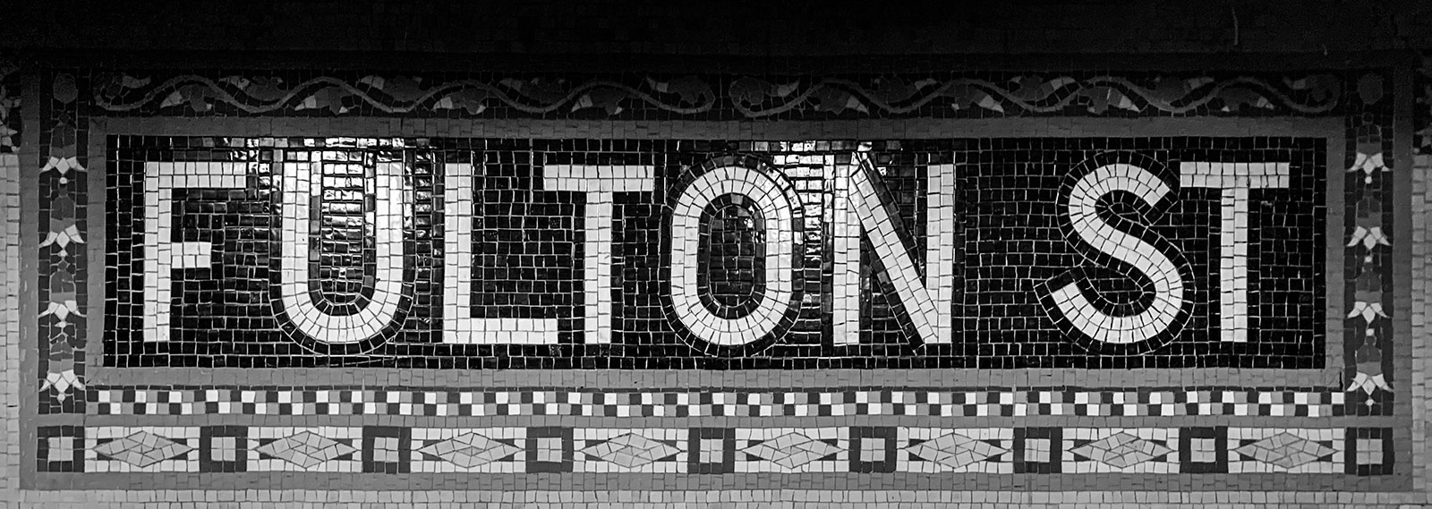 Mosaic name tablet at Fulton St