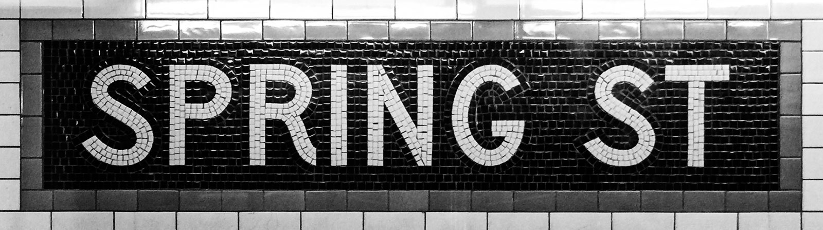 Mosaic name tablet at Spring street